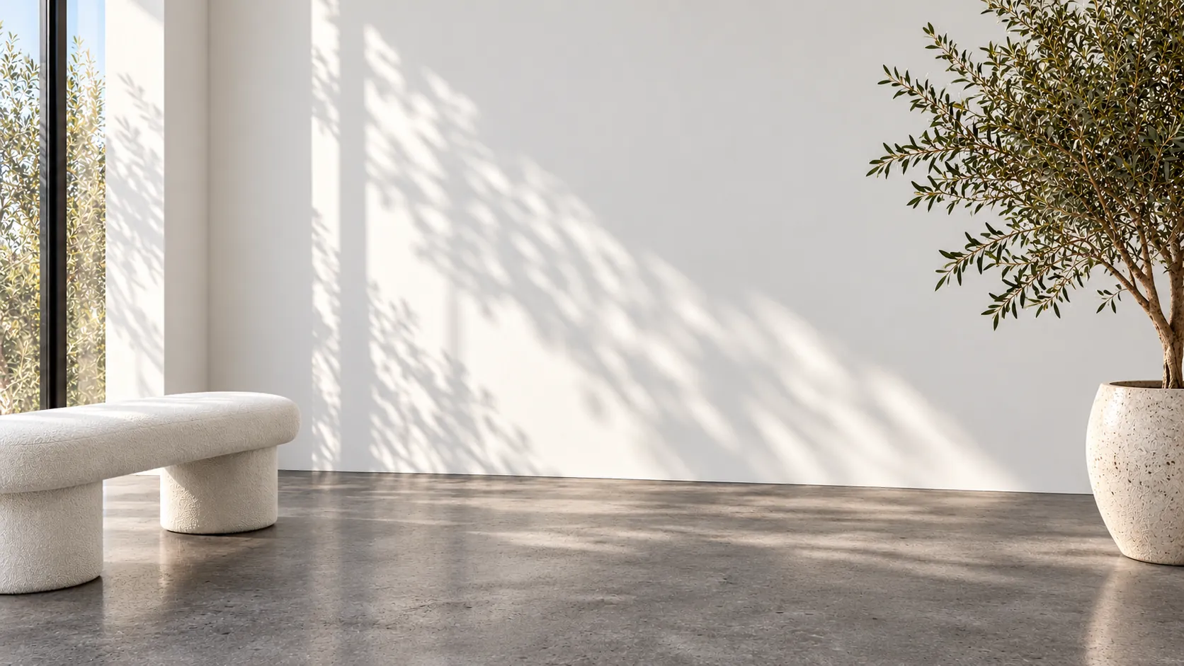 Minimalist clinic corner with a cream bouclé bench and an olive tree at Push Med in Greenville SC
